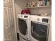 Bright laundry room featuring a modern washer and dryer set with ample shelving for storage at 2101 S Meridian Rd # 199, Apache Junction, AZ 85120