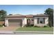 Inviting single story stucco home showcasing a beautiful tile roof, an arched entry, and manicured landscaping at 23130 E Lords Way, Queen Creek, AZ 85142