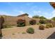 Backyard with desert landscaping and flowering shrubs at 23162 W Lasso Ln, Buckeye, AZ 85326