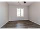 Stylish bedroom features hard surface floors, natural lighting, and a modern ceiling fan at 23162 W Lasso Ln, Buckeye, AZ 85326