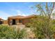 Landscaped front yard with desert plants leading to the front door and tiled roof at 23162 W Lasso Ln, Buckeye, AZ 85326