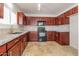 Well-equipped kitchen with granite countertops, dark cabinets, and stainless steel appliances at 23162 W Lasso Ln, Buckeye, AZ 85326