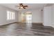Open-concept living room with plantation shutters and views into the sun room at 23162 W Lasso Ln, Buckeye, AZ 85326