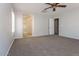 Bright main bedroom featuring plush carpeting, an archway and access to the en suite bathroom at 23162 W Lasso Ln, Buckeye, AZ 85326