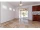 Bright sun room featuring a sliding glass door with plantation shutters and tile floors at 23162 W Lasso Ln, Buckeye, AZ 85326