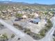 Aerial view of house with dirt road access and detached garage on a large lot at 2627 W Buckskin Trl, New River, AZ 85087