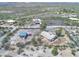 Aerial view showing large lot including the house, detached garage, and outbuildings at 2627 W Buckskin Trl, New River, AZ 85087