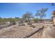 Gravel backyard with small shrubs and perimeter fencing at 2627 W Buckskin Trl, New River, AZ 85087