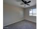 Bedroom with new carpet, ceiling fan, and a window with outdoor views at 2627 W Buckskin Trl, New River, AZ 85087