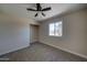 Bedroom with new carpet, ceiling fan, and a closet with window views at 2627 W Buckskin Trl, New River, AZ 85087