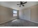 Cozy bedroom with carpet flooring, ceiling fan, and a bright window at 2627 W Buckskin Trl, New River, AZ 85087