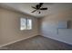 Neutral toned bedroom with fan and large window providing ample natural light at 2627 W Buckskin Trl, New River, AZ 85087