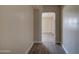 Hallway with new floor leading to an archway and living area at 2627 W Buckskin Trl, New River, AZ 85087
