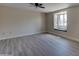 Bright living room featuring new floors, a window seat, and a ceiling fan at 2627 W Buckskin Trl, New River, AZ 85087