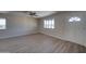 Bright, open living room with a ceiling fan, new laminate floors, and ample natural light at 2627 W Buckskin Trl, New River, AZ 85087