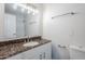 Bright bathroom featuring a granite countertop vanity, decorative lighting, and a convenient shower at 2728 W Redfield Rd, Phoenix, AZ 85053