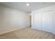 Bright bedroom featuring neutral carpet, closet, and access to additional room at 2728 W Redfield Rd, Phoenix, AZ 85053