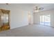Large bedroom featuring a ceiling fan, plush carpet and a sliding glass door to the patio at 2728 W Redfield Rd, Phoenix, AZ 85053