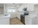 Modern kitchen featuring white cabinets, quartz countertops, and stainless steel appliances at 2728 W Redfield Rd, Phoenix, AZ 85053