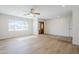 Bright and spacious living room featuring wood-look floors, a ceiling fan, and recessed lighting at 2728 W Redfield Rd, Phoenix, AZ 85053