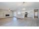 Open-concept living space featuring a brick fireplace, wood-look floors, and a modern kitchen at 2728 W Redfield Rd, Phoenix, AZ 85053