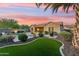 Expansive backyard featuring a pool, patio, lush turf, and desert landscaping at 27308 N 56Th Dr, Phoenix, AZ 85083