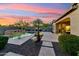 Inviting backyard with a sparkling pool, water feature, and cozy patio area at 27308 N 56Th Dr, Phoenix, AZ 85083