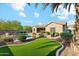 Lush backyard featuring a manicured lawn, sparkling pool, and cozy outdoor seating area at 27308 N 56Th Dr, Phoenix, AZ 85083