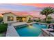 Relaxing backyard oasis featuring a sparkling pool, covered patio, and lush landscaping at 27308 N 56Th Dr, Phoenix, AZ 85083