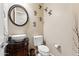 Elegant powder room with modern vessel sink, dark wood vanity, and decorative wall accents at 27308 N 56Th Dr, Phoenix, AZ 85083
