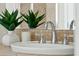 Close up of a bathroom sink with chrome faucet and decorative plants at 27308 N 56Th Dr, Phoenix, AZ 85083