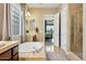 Bathroom features a soaking tub, dual sinks, glass block window and separate shower at 27308 N 56Th Dr, Phoenix, AZ 85083