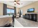 Bright bedroom features a ceiling fan, dark furnishings and lots of natural light at 27308 N 56Th Dr, Phoenix, AZ 85083