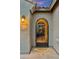 Elegant entryway with decorative iron gate and a glimpse into a warmly lit interior at 27308 N 56Th Dr, Phoenix, AZ 85083