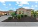 Beautiful home showcasing well-maintained desert landscaping and charming architectural details at 27308 N 56Th Dr, Phoenix, AZ 85083