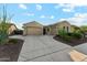 Charming home featuring a three-car garage, desert landscaping, and a tile roof at 27308 N 56Th Dr, Phoenix, AZ 85083