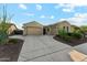Charming single-story home boasting a three-car garage and desert landscaping with a wide driveway at 27308 N 56Th Dr, Phoenix, AZ 85083