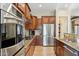View of kitchen, featuring stainless steel appliances, granite countertops, and well-crafted wooden cabinetry at 27308 N 56Th Dr, Phoenix, AZ 85083