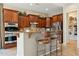 Stylish kitchen features granite countertops, wooden cabinets, island with seating, and stainless steel appliances at 27308 N 56Th Dr, Phoenix, AZ 85083