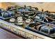 Close-up of gas cooktop with a modern design and a sleek stainless steel trim at 27308 N 56Th Dr, Phoenix, AZ 85083
