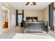 Comfortable main bedroom with a decorative bed, neutral walls, carpet, and natural light from the window at 27308 N 56Th Dr, Phoenix, AZ 85083