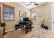 Office featuring a standing desk, guitar and ample natural light at 27308 N 56Th Dr, Phoenix, AZ 85083