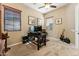 Well-lit home office with desk, guitar, natural light, and carpeted floor at 27308 N 56Th Dr, Phoenix, AZ 85083