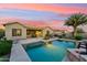 Inviting backyard pool and patio area, perfect for entertaining with a beautiful sunset at 27308 N 56Th Dr, Phoenix, AZ 85083