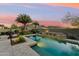 Beautiful backyard swimming pool with integrated water feature and mountain views at sunset at 27308 N 56Th Dr, Phoenix, AZ 85083