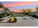 Sparkling pool with cascading water feature, complemented by lush landscaping and mountain views at 27308 N 56Th Dr, Phoenix, AZ 85083