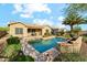 Tranquil pool with elegant water feature, surrounded by lush landscaping and a covered patio at 27308 N 56Th Dr, Phoenix, AZ 85083