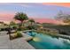 Stunning pool area featuring a water feature, mature palm trees, and picturesque mountain backdrop at 27308 N 56Th Dr, Phoenix, AZ 85083