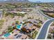 An aerial view of desert homes with swimming pools and solar panels, nestled in a well-planned community at 27809 N Silverado Ranch Rd, Peoria, AZ 85383