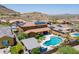 Aerial view highlighting the pool, outdoor kitchen, and lush landscaping of this backyard oasis at 27809 N Silverado Ranch Rd, Peoria, AZ 85383